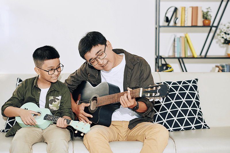 father-son-play-guitar